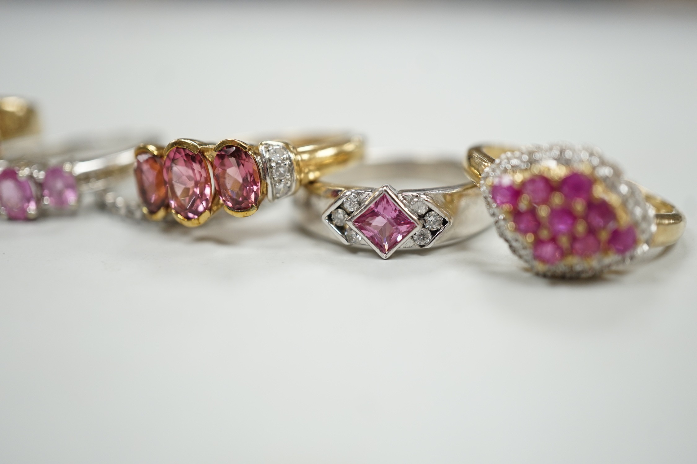 Five assorted modern 9ct gold and gem set dress rings, gross weight 16.7 grams and one other white metal and gem set eternity ring.